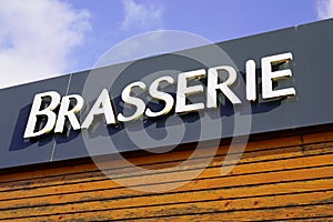 brasserie means beer bar sign text on pub a city street storefront building photo