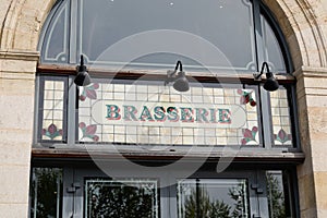 Brasserie restaurant text sign paint on wall facade french building city street photo