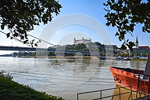 A Red Boat by the Danube with Bratislava Castle in the Background