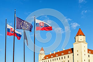 Bratislava castle and flags of Slovak republic and European Union