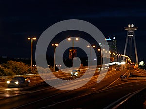 Bratislava-evening view of the SNP bridge and UFOs on the Danube river and tall houses in the background,Slovakia