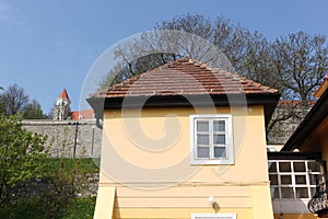 Bratislava, Slovakia - April, 2011: small yellow house with Bratislava Castle view.
