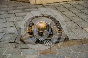 BRATISLAVA, SLOVAKIA: Bronze sculpture of plumber in Bratislava. Statue Mr. Cumil. The Watcher- or Man at work