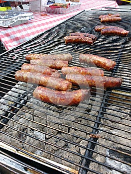 Brats Cook On A Charcoal Grill, Barbequing Sausages