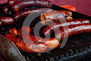 Bratwurst sausages on cast iron griddle.