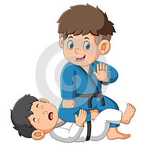 The brave boy is beating his friend on the battle of karate