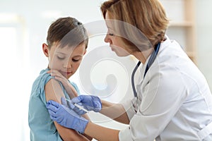 Brave boy receiving injection or vaccine with a smile