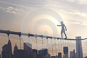 Brave boy walking on a wire above the metropolis, conceptual image