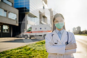 Brave coronavirus paramedic in front of isolation hospital facility.Covid-19 emergency room doctor with protective glasses / mask