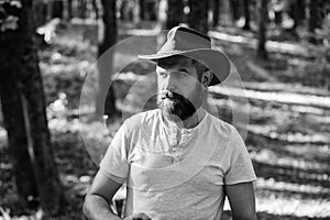 Brave cowboy. camping and hiking. mature male with brutal look. Bearded man in cowboy hat walk in park outdoor. man