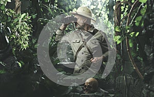 Explorer with binoculars in the jungle