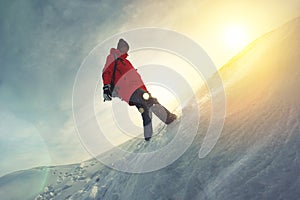 Brave girl with a backpack walking on snow-covered field