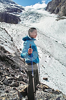 Brave girl conquering mountain peaks of the Altai mountains. The majestic nature of the mountain peaks and lakes. Hiking