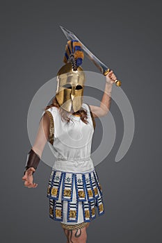 Brave greek soldier woman with gladius against gray background