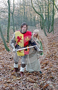 Brave knight and maid in forest photo