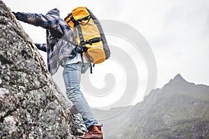 Brave lifestyle climber with professional backpack climb to the rock