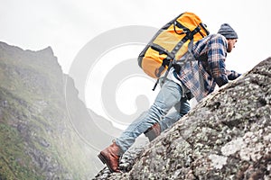 Brave lifestyle man tourist conquers the mountains photo