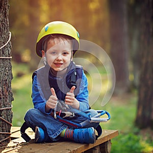 Brave little boy having fun at adventure park and giving double