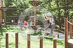 Brave little girl in the forest adventure park