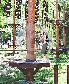 Brave little girl in the forest adventure park