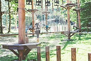 Brave little girl in the forest adventure park