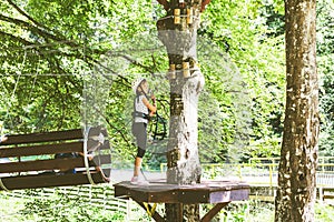 Brave little girl in the forest adventure park