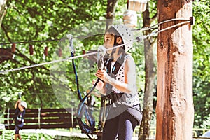 Brave little girl in the forest adventure park