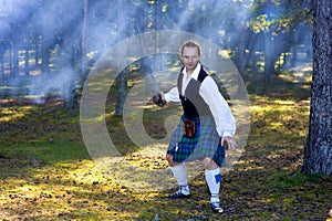 Brave man in scottish costume with sword