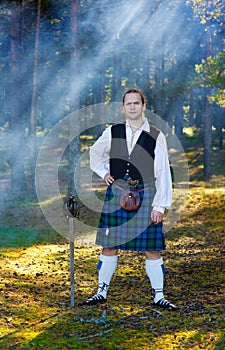 Brave man in scottish costume with sword