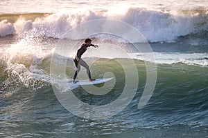 Brave teenager making tricks on the rough sea