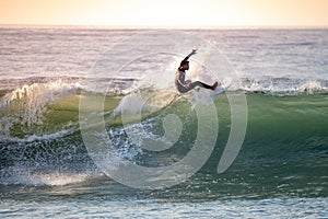 Brave teenager making tricks on the rough sea