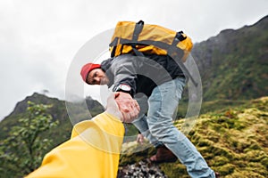 Brave traveler hold hand his friend for helping climb to mountain lifestyle outdoor journey photo