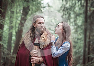 Brave Warrior Viking man with beautiful medieval woman standing