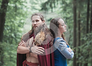 Brave Warrior Viking man with beautiful medieval woman standing