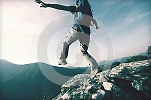 Brave woman hiker walking to the cliff edge