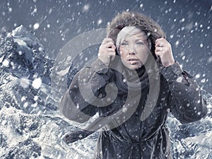 Braving the conditions to reach the top. Cropped shot of an attractive young woman hiking in the midst of a snow storm.