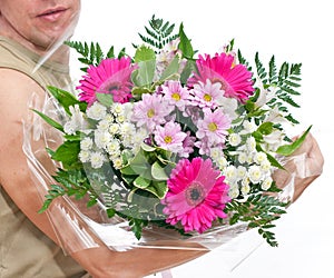 Brawny man s hand with a bouquet of flowers photo