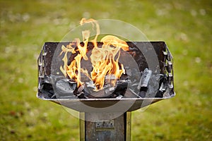 A brazier with charcoal and flame in it