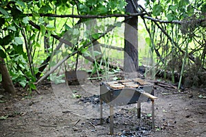 Brazier with grille and slices of bread on a