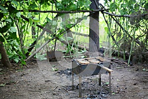 Brazier with grille and slices of bread on a photo