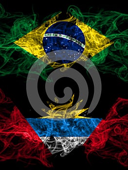 Brazil, Brazilian vs Antigua and Barbuda, Antiguan and Barbudan smoky mystic flags placed side by side. Thick colored silky