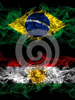 Brazil, Brazilian vs Kurdistan, Kurdish, Kurds smoky mystic flags placed side by side. Thick colored silky abstract smoke flags