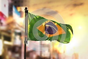 Brazil Flag Against City Blurred Background At Sunrise Backlight photo