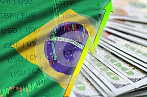 Brazil flag and chart growing US dollar position with a fan of dollar bills photo