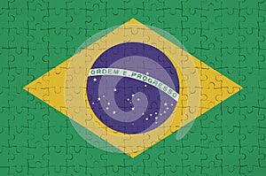 Brazil flag is depicted on a folded puzzle photo