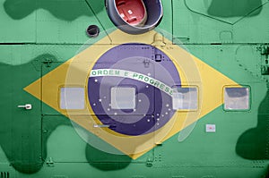 Brazil flag depicted on side part of military armored helicopter closeup. Army forces aircraft conceptual background photo