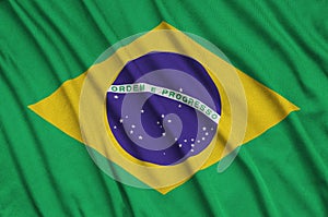 Brazil flag is depicted on a sports cloth fabric with many folds. Sport team banner photo