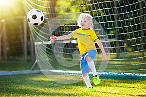 Brazil football fan kids. Children play soccer.