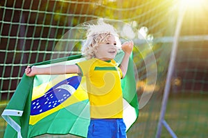 Brazil football fan kids. Children play soccer.