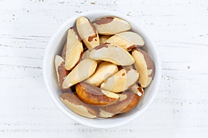 Brazil nut nuts from above bowl wooden board photo